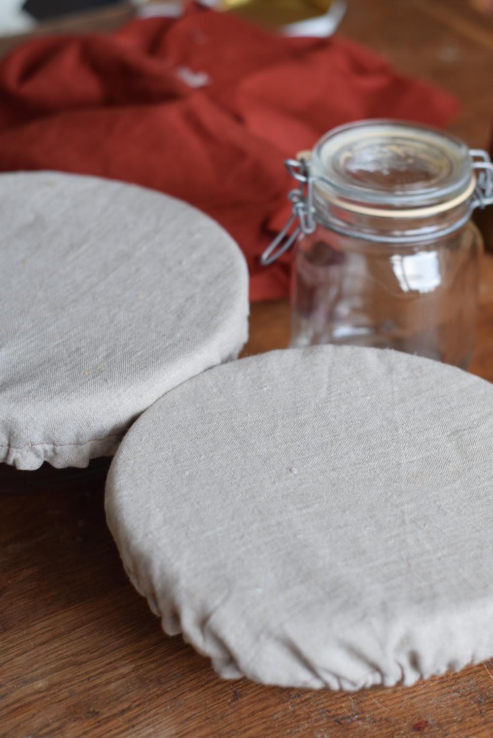 Two glass bowls with a linen fabric bowl cover.