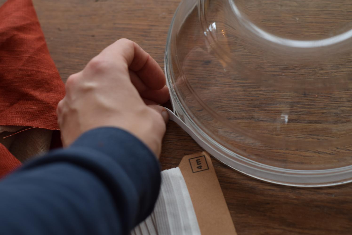 Measuring elastic for a fabric bowl cover around a glass mixing bowl