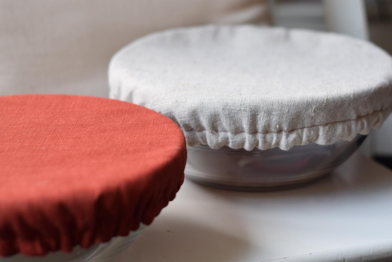 This image showcases the completed fabric bowl covers, featuring one in rustic cotton and the other in sandy linen covering the glass mixing bowls.