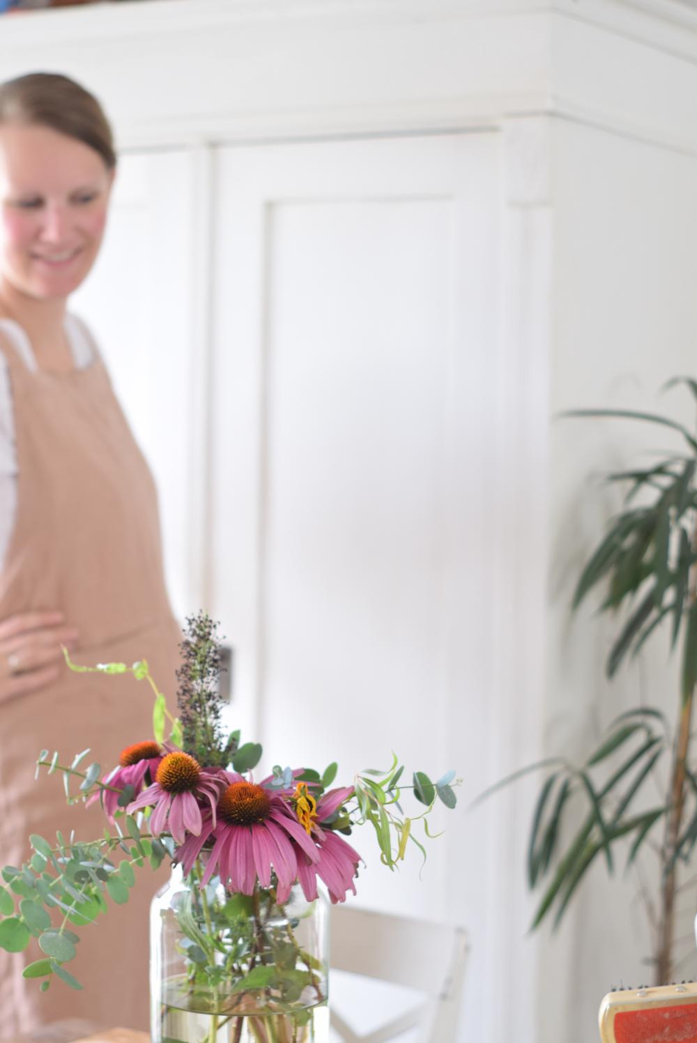 Bouquet of freshly cut coneflowers in a vase.