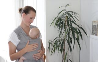 Homemaker with baby in a baby carrier